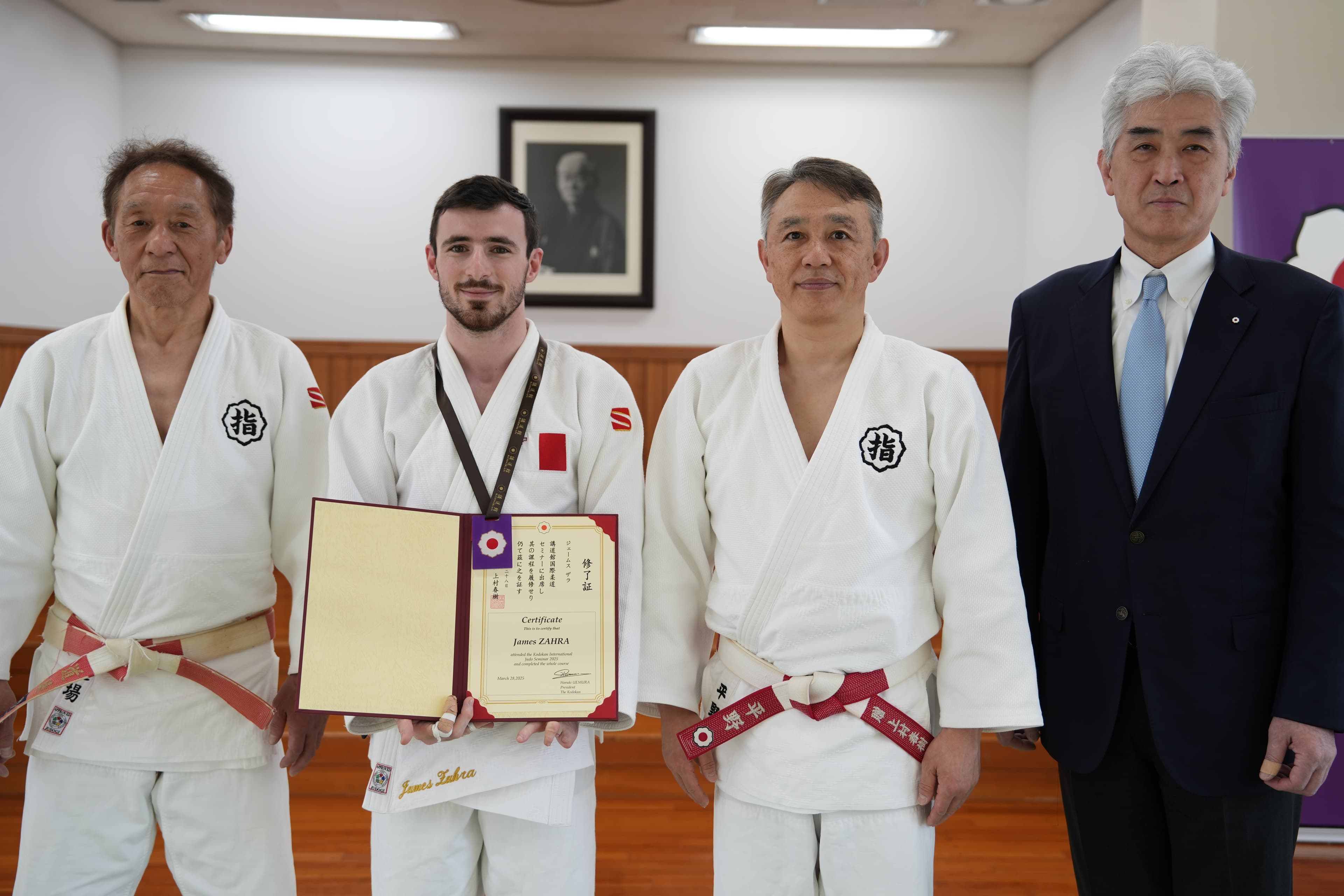 IIJC coach receiving Kodokan coaching certificate in Japan